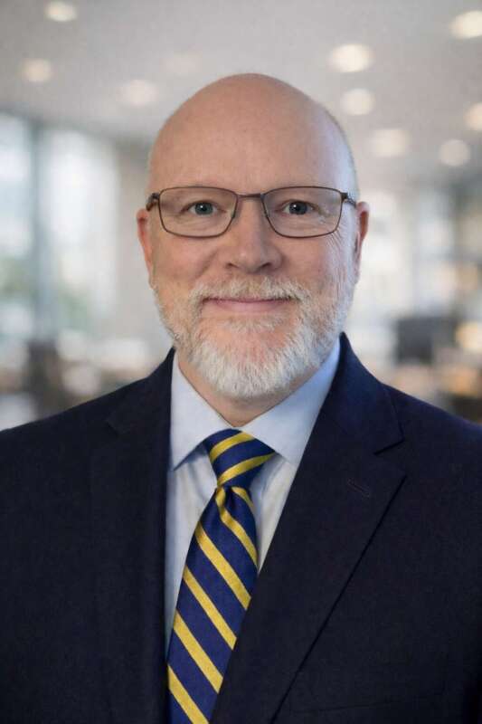 Photo of President Cameron Wesson in a suit and striped tie.