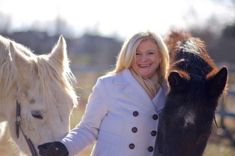 Dr. Lois Jarman, Director of the Intensive English Language Program, and her horses