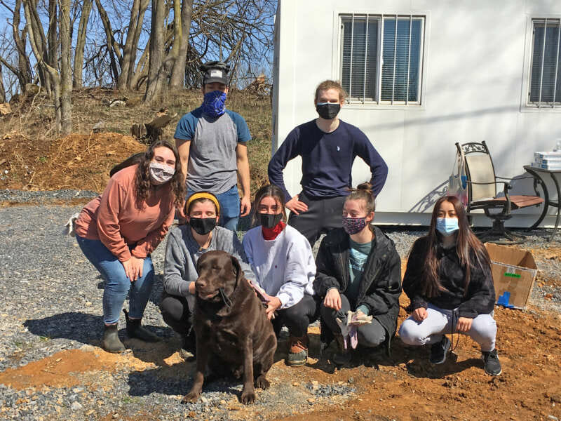 Charlie the dog delivered lunch to students who performed community service at Shepherd’s Agricultural Innovation Center at Tabler Farm. Pictured (front row, l. to r.) are Danielle Stephenson, graduate assistant for student community service, Charles Town; Veronica McDade, M.B.A. student, Clarksburg, Maryland; Kaylee Uppercue, secondary education major, Martinsburg; Julia Shroades, business administration major, Inwood; and Ilse Luna, nursing major, Mexico, back row, Conner McManus, computer and information sciences major, Falling Waters; and William Prudnick, chemistry major, Martinsburg