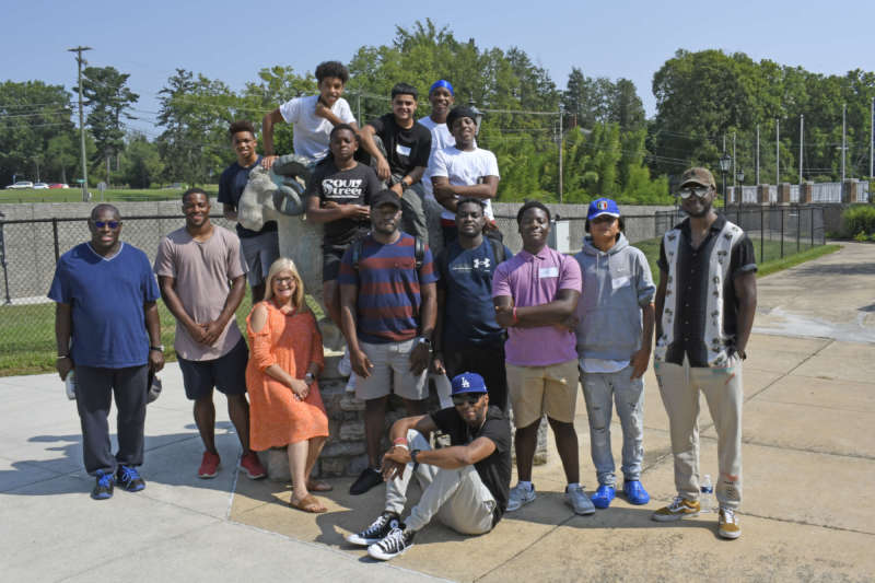 Students from I Believe in Me, Inc. pose at the ram statue in Walter Barr Plaza with Shepherd international students and employees. 