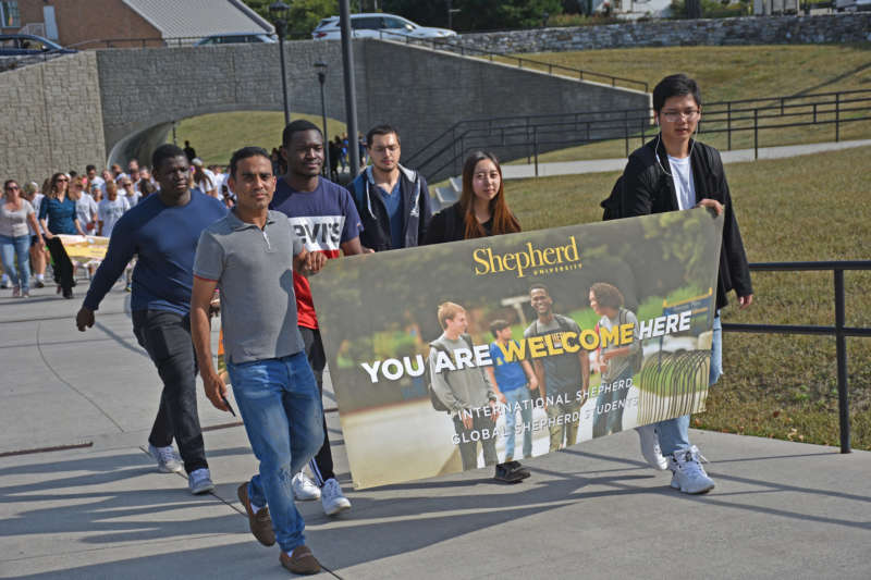 Students carry a banner during the 2019 Founders Day parade.