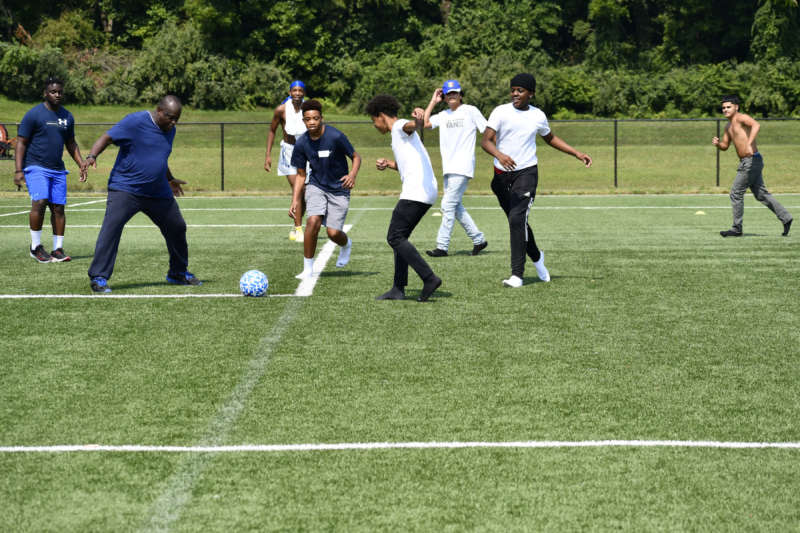 Students from I Believe in Me of Frederick, Maryland, play soccer with international students from Shepherd during a campus visit.