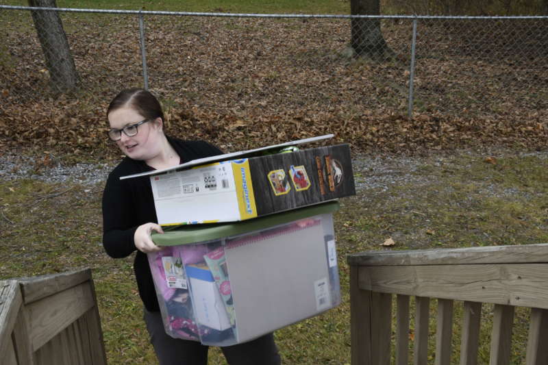 Shelby Maly, student affairs coordinator for social media and special initiatives, brings a box of toys to the Salvation Army.