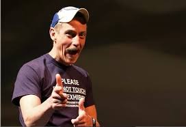 Storyteller Bil Lepp points "finger guns" at the viewer while smiling.