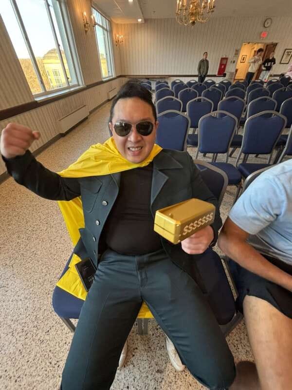 Member of a fraternity participating in Spirit Week wears a superhero costume. 