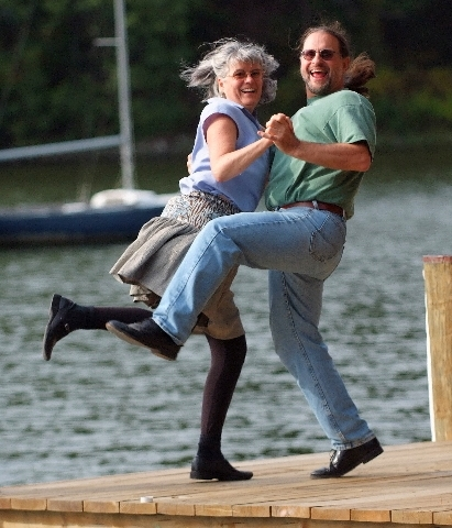 Cloggers Kim Forry and Jan Scopel are pictured dancing on a pier in front of the bay in Annapolis